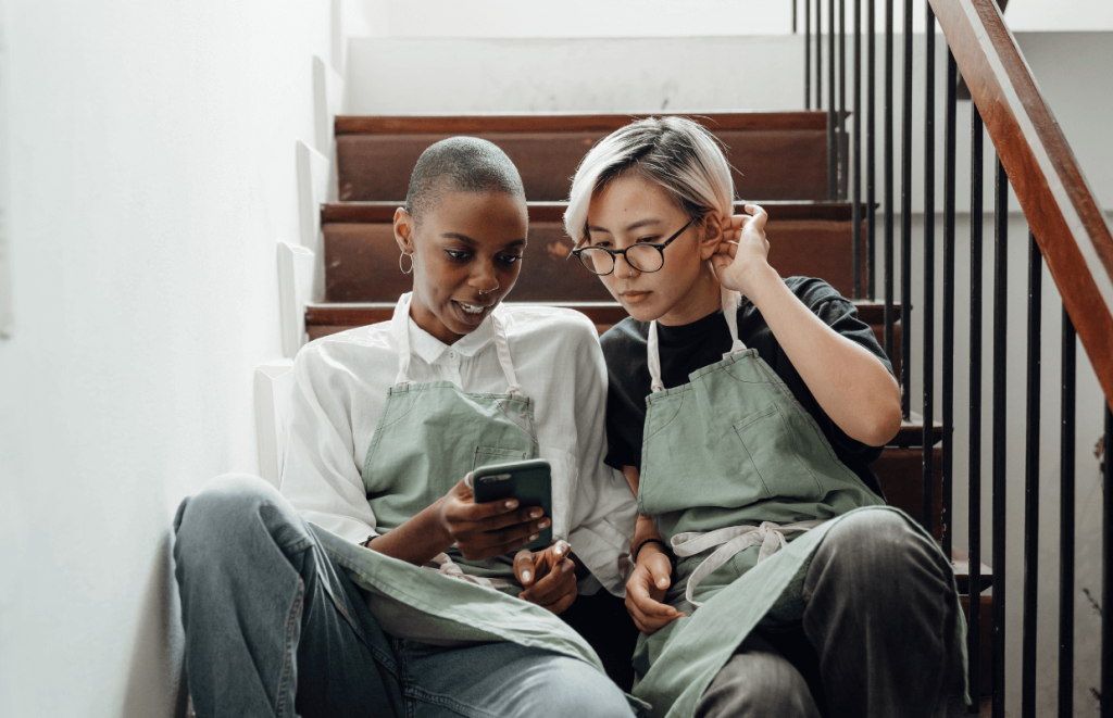 Two hospitality workers discussing earning more money
