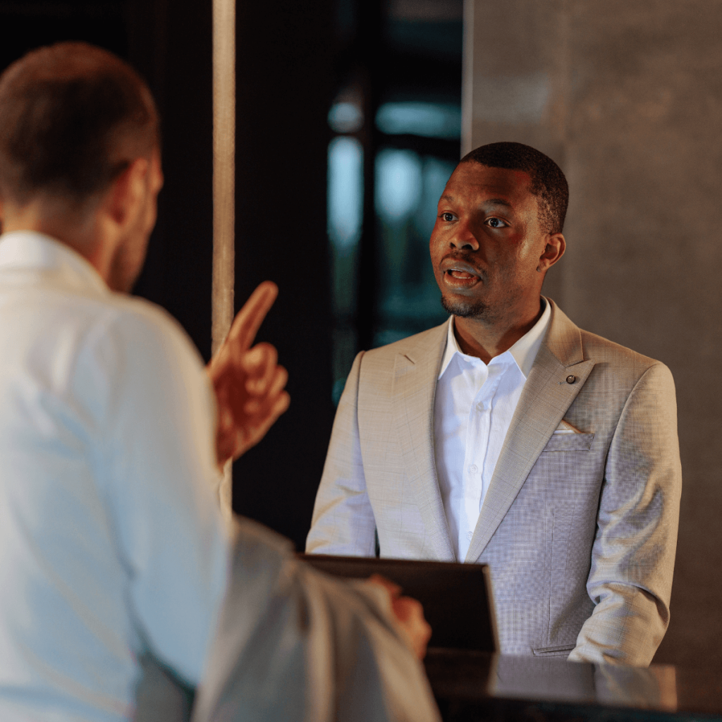 How to Handle Customer Complaints - hotel guest complaining to male receptionist