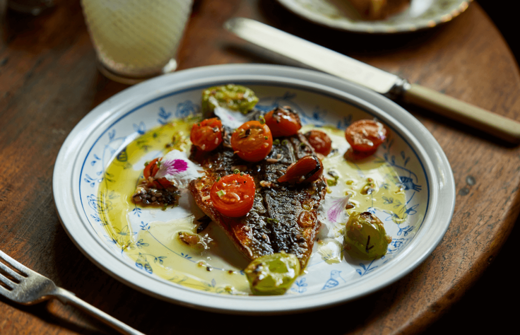 Homegrown Hospitality: A Plate with fish tomatoes and olive oil